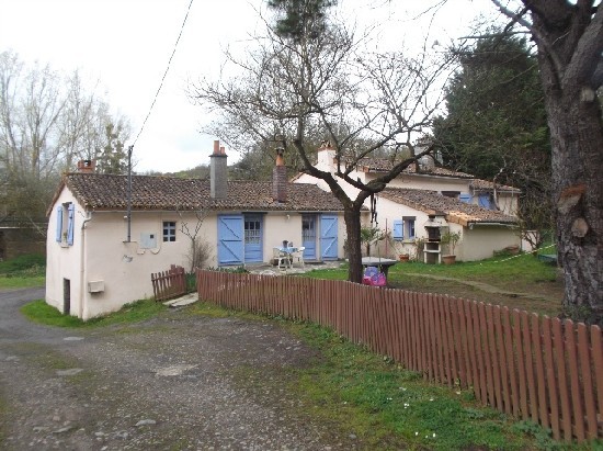 House Near River at Edge of Village