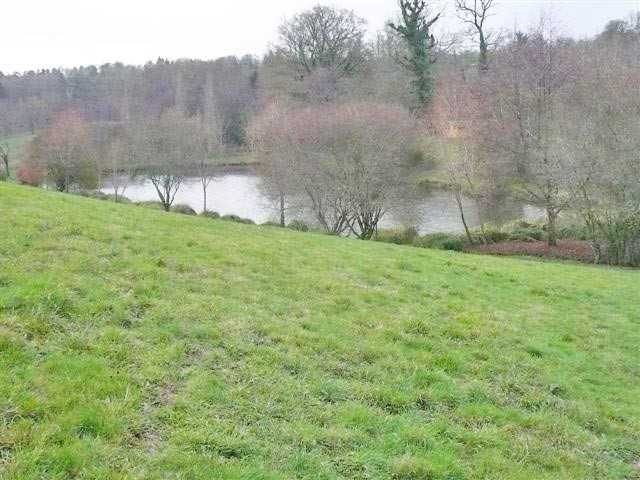 Lake With Chalets And Wood Land