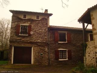 Renovated stone house with a river..