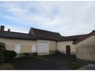 House with barns and small wood.