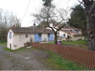 House Near River at Edge of Village