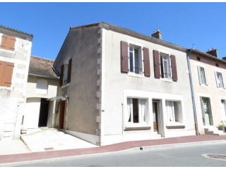 Village house with garage and garden.