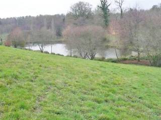 Lake With Chalets And Wood Land