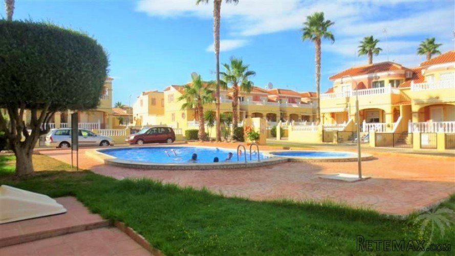 This bungalow is located in a green area with three..