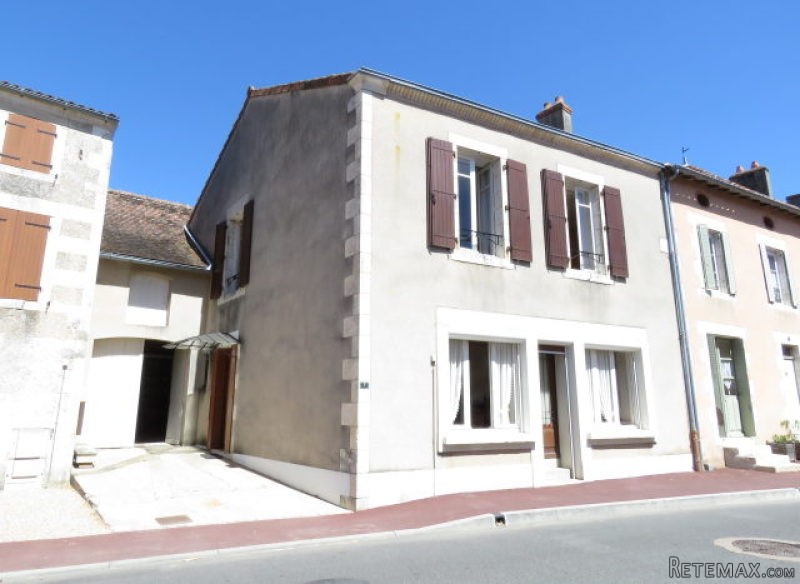 Village house with garage and garden.