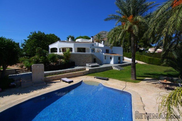 This impressive Ibiza style villa is located within walking..