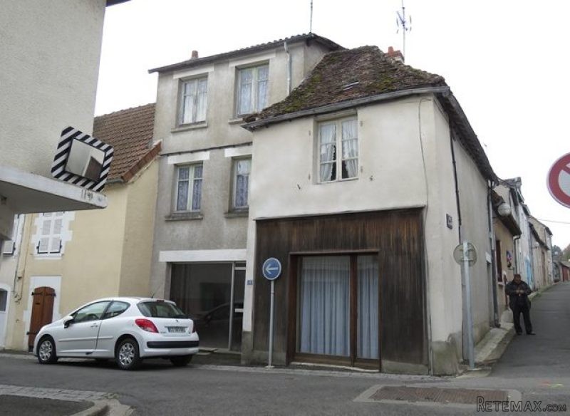 Big townhouse with shopfronts to..