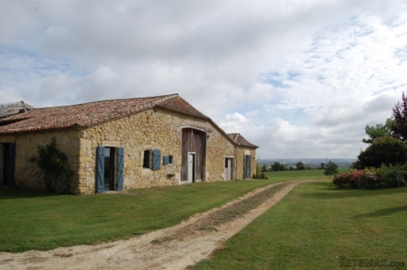 APS2220 A large stone farmhouse with an..